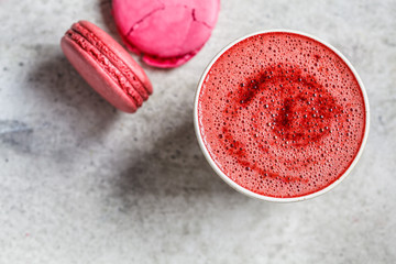 Pink beetroot latte in a ceramic glass, top view.