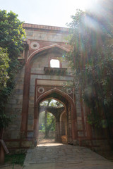 beautiful gate at humanyuns tomb surrounded by trees in delhi, india