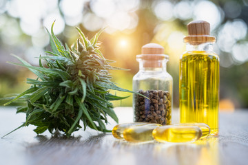 Glass bottles that contain CBD hemp oil and tablets extracted from the hemp oil concept Alternative...