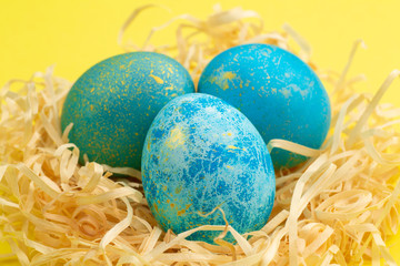 Easter egg painted blue with gold.