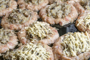 Minced meat balls stuffed with mushrooms close-up. Before baking