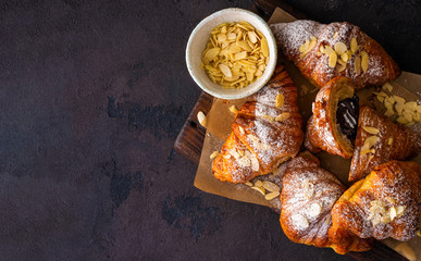 Vegan croissants with almond flakes and icing sugar top view