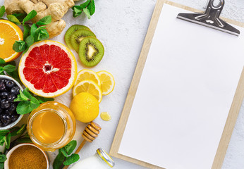 Clipboard with healthy products for Immunity boosting or diet food top view. Vegetables and fruits to boost immune system