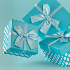 Collection of blue gift boxes with ribbons on blue background Copy space