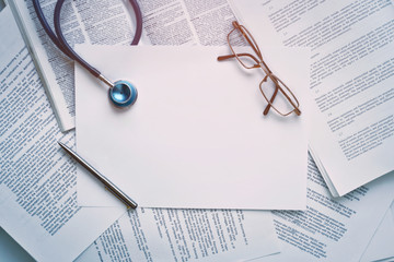 Medical regulatory documents and a dictionary on the table. Medical translation service. Medical writing. Medical regulatory service.
