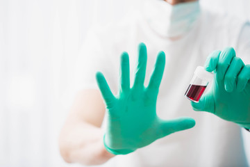 Doctor holds blood tube test, concept of coronavirus pandemic.