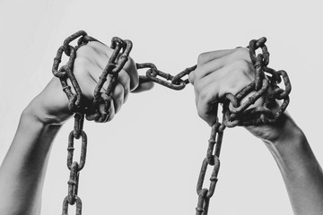 human hands in iron chains