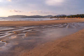 beautiful reflexions in the water at the beach in goa, india
