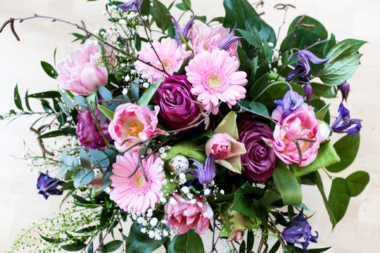 Bright and colorful flower bouquet for an easter occasion with easter eggs, roses, gerbera and other flowers and foliage