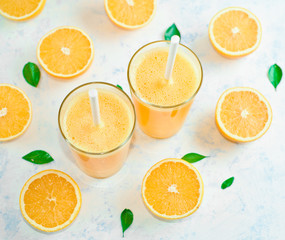 orange juice in a glass, top view, slices of oranges, straw, healthy lifestyle concept
