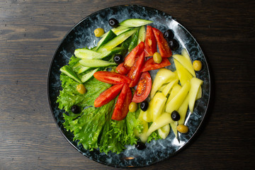  assorted fresh vegetables, tomato, cucumber, pepper, lettuce, olives
