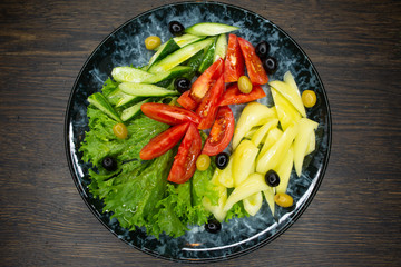  assorted fresh vegetables, tomato, cucumber, pepper, lettuce, olives
