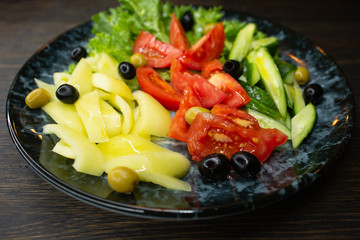  assorted fresh vegetables, tomato, cucumber, pepper, lettuce, olives