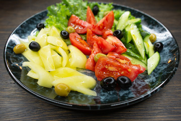  assorted fresh vegetables, tomato, cucumber, pepper, lettuce, olives