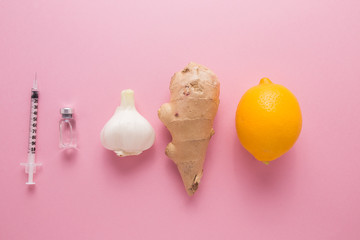 Lemon garlic ginger on a pink background. The body's natural defense against disease. The choice to take natural medicines or pharmacology.