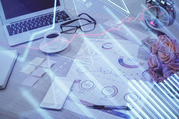 Financial chart drawing and table with computer on background. Double exposure. Concept of international markets.