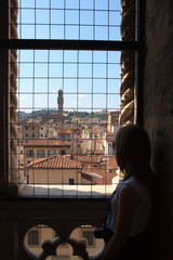 Fototapeta na wymiar Firenze, Italy - April 21, 2017: A girl look Florence city center from a window, Firenze, Tuscany, Italy