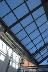 modern internal structure of glass roof construction with lockable windows sections, inside view of modern glass roof
