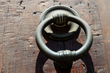 Firenze, Italy - April 21, 2017: An old knocker on a door in Florence, Firenze, Tuscany, Italy