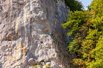 Rock climber ascending a challenging cliff