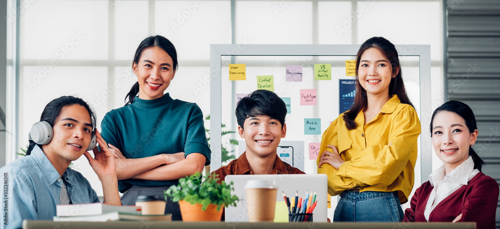 Poster Portrait of asian ux developer and ui designer arms crossed and smile with confidence at modern office.Creative digital development agency