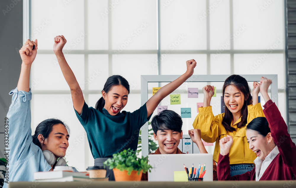 Aufkleber asian ux developer and ui designer arms raise for successful design at modern office.creative digita
