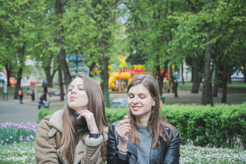 Fototapeta premium two girls in the park on the lawn