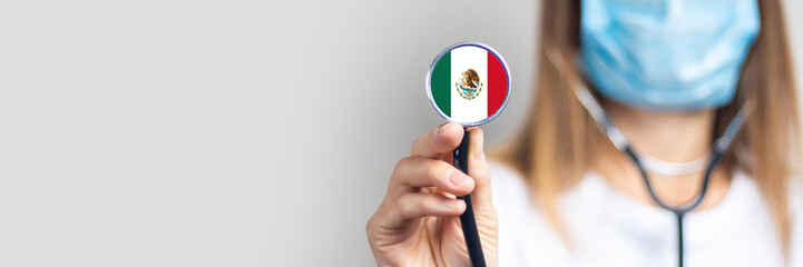 female doctor in a medical mask holds a stethoscope on a light background. Added flag of Mexico....