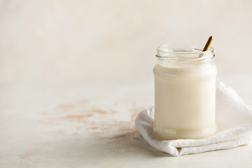 Healthy breakfast. Thermostatic fermented milk product yogurt in a glass jar with space for text on the left.