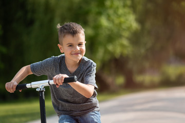 Kid enjoying as he rides his skate scooter