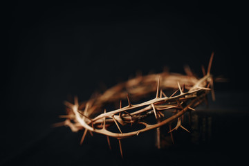  ธhe crown of thorns of Jesus upon holy bible on black  background with copy space, can be used for Christian background, Easter concept
