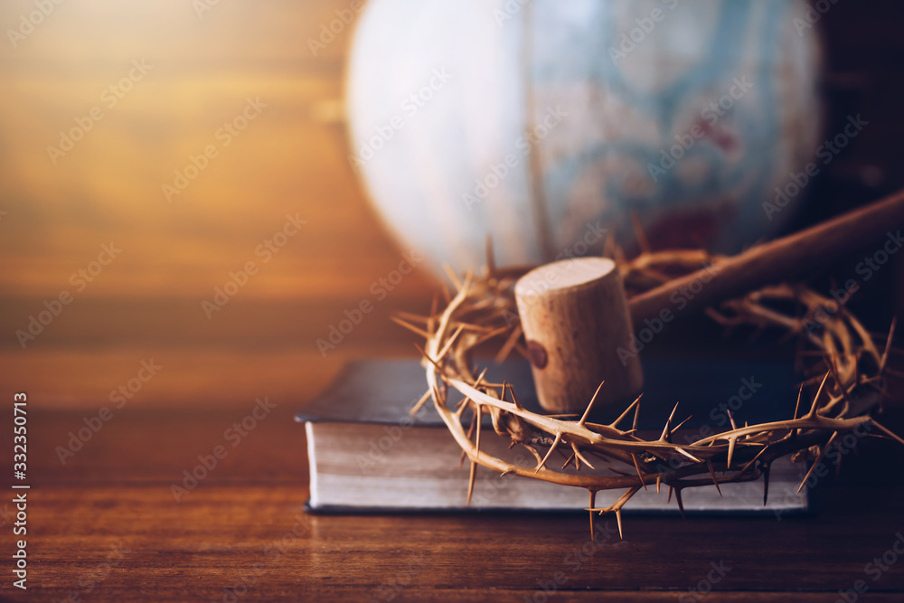 Wall mural Close up of crown of thorns of Jesus and wooden hammer look like Judge gavel on  bible over Blurred world globe  on wooden table. Christian background show God justice and Christ's redemption  concept