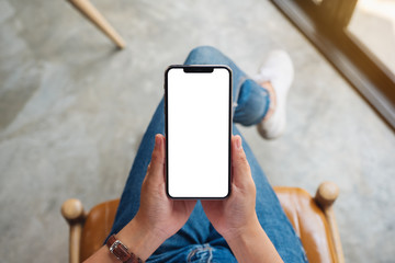 Top view mockup image of a woman holding mobile phone with blank white screen