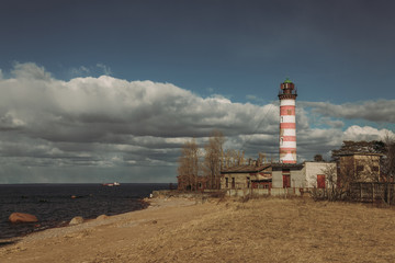 lighthouse on the seashore at sunset