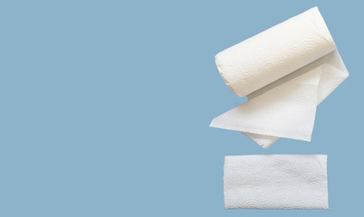 Paper towel. A roll of white paper towel on a sky blue background. The concept of personal hygiene, sanitation top view