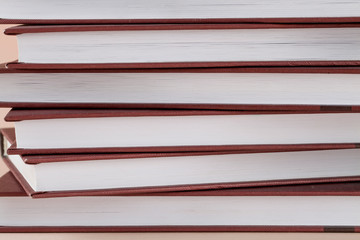 Close view of stack books on brown background