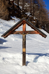 Devero Park ( Verbano-Cusio-Ossola ), Italy - January 15, 2017: A Christ wooden sculpture in Alpe Devero Park, Ossola Valley, VCO, Piedmont, Italy
