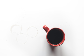 Red coffee splashing in a cup isolated on white background