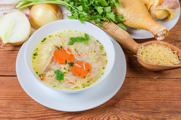 Chicken vermicelli soup in bowl against the some raw ingredients