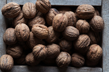 Walnuts with and without shells (filling the picture). Background of fresh walnuts.