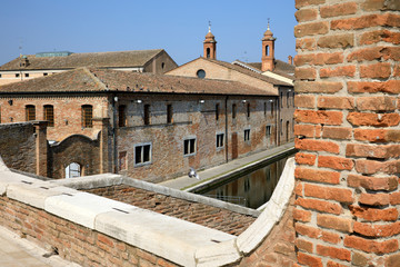 Fototapeta premium Comacchio (FE), Italy - April 30, 2017: View of houses and bridge in Comacchio village, Delta Regional Park, Emilia Romagna, Italy
