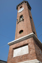 Fototapeta premium Comacchio (FE), Italy - April 30, 2017: The clock tower in Comacchio village, Delta Regional Park, Emilia Romagna, Italy