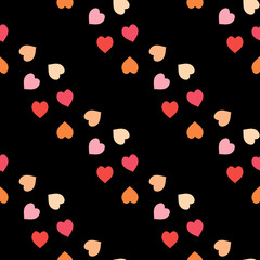 Seamless pattern with exquisite red, pink and orange hearts on black background for plaid, fabric, textile, clothes, tablecloth and other things. Vector image.