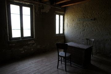Naklejka premium Po river (FE), Italy - April 30, 2017: A old chair and table in a fisherman's houses inside on Po river, Delta Regional Park, Emilia Romagna, Italy