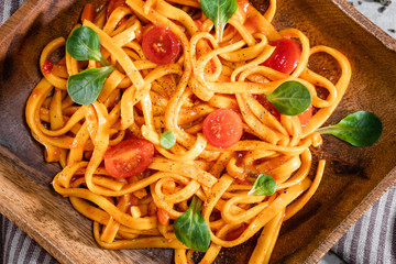 Pasta with tomato sauce and basil. Delicious tagliatelle. Italian tasty food