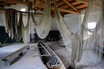 Po river (FE),  Italy - April 30, 2017: Nets and boat into an old Fisherman's house on Po river, Delta Regional Park, Emilia Romagna, Italy
