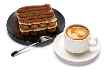 Classic tiramisu dessert on ceramic plate and cup of coffee isolated on white background with clipping path