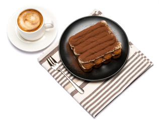 Classic tiramisu dessert on ceramic plate and cup of coffee isolated on white background with clipping path