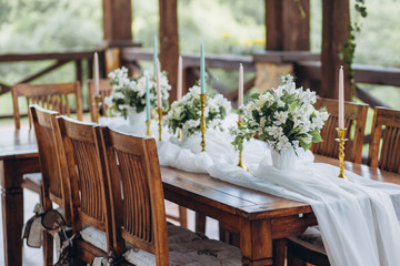 The wedding table decorated with fresh flowers is newlywed with a view of the mountains. 