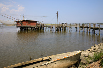 Fototapeta premium Po river (FE), Italy - April 30, 2017: A Fisherman's boat on a side of Po river, Delta Regional Park, Emilia Romagna, Italy